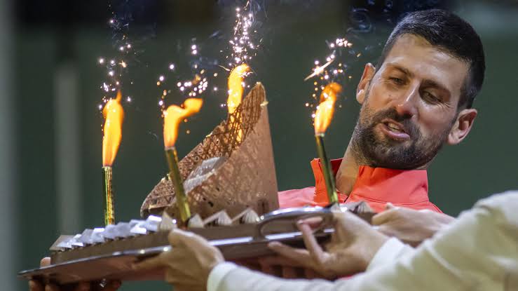 Novak Djokovic makes an address after a fiery revenge win on his birthday after racket smash